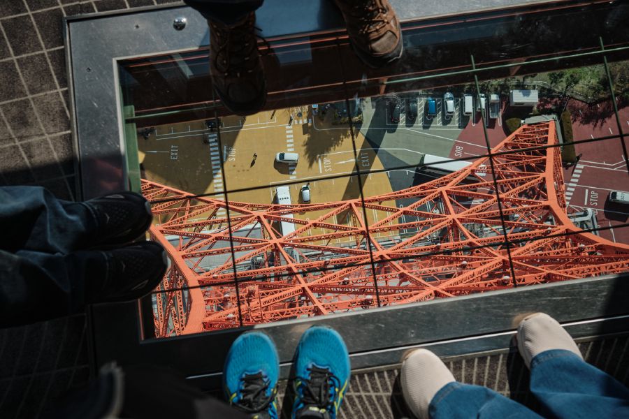 Family feet looking at the feet of Tokyo Tower
