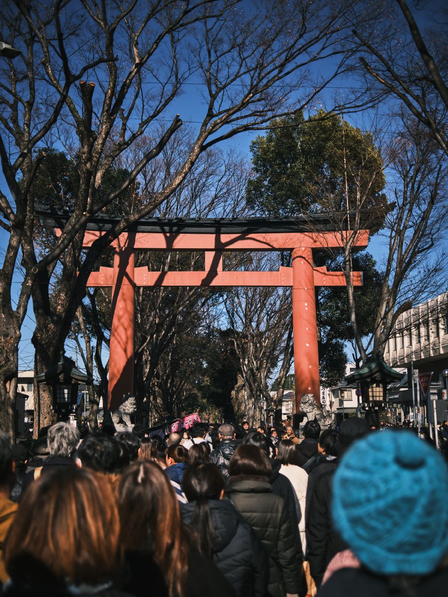 
On our way to the shrine. Street stalls with food, games, drinks filled one side of the street. A crowd of people on the other side hanging out and wading through towards the shrine.
